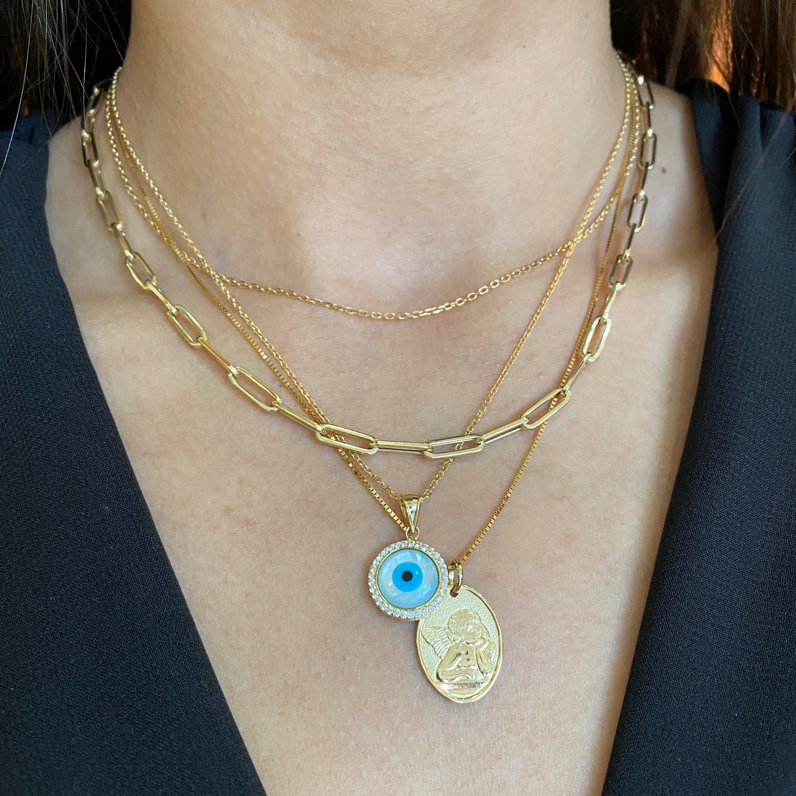di evil eye and baby angel necklace stack
